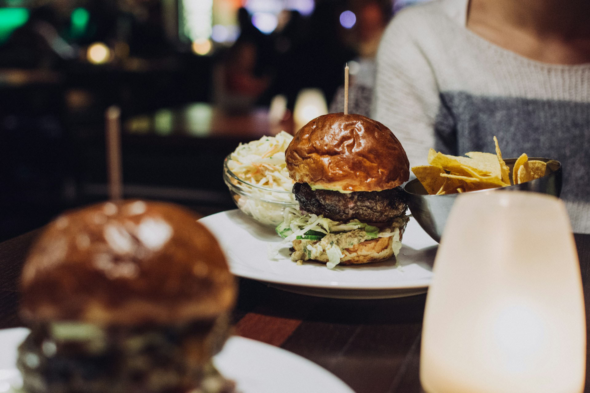 Server bringing a burger to a table