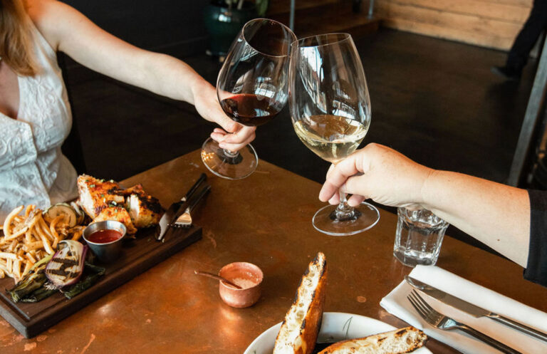 Toasting wine glasses over a table