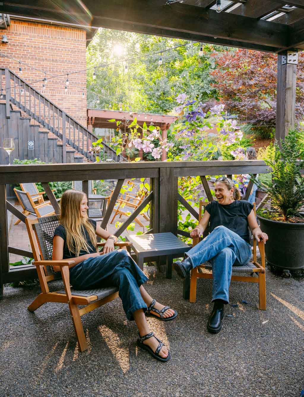 Mother and daughter laughing in a garden